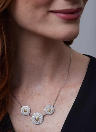 Close up of red haired model wearing Sterling Silver Celtic Warrior Triple Disc Pendant with 18ct Gold Bead
